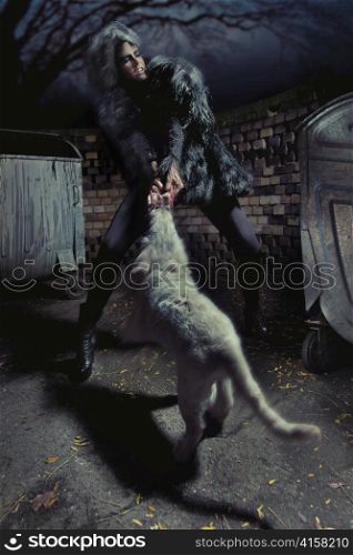 Woman fighting with a dog.