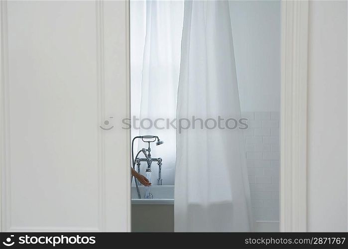 Woman filling bathtub