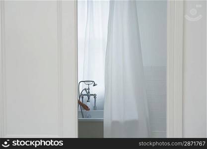 Woman filling bathtub