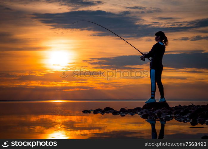 Woman fishing on Fishing rod spinning in Finland