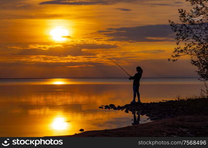 Woman fishing on Fishing rod spinning in Finland