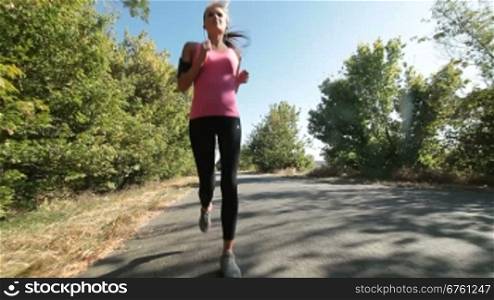 Woman fitness jogging workout on countryside road