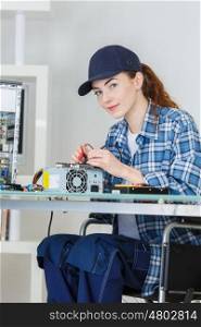 woman fixing a computer at work