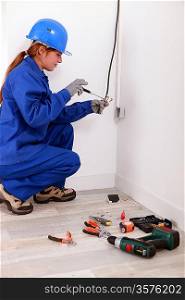 Woman fixing house electrics