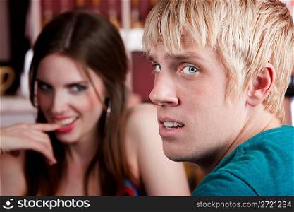 Woman flirting with uninterested male friend