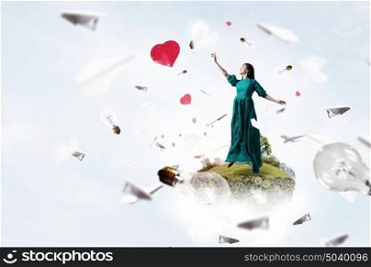 Woman floating in sky. Elegant woman in green long dress floating in sky
