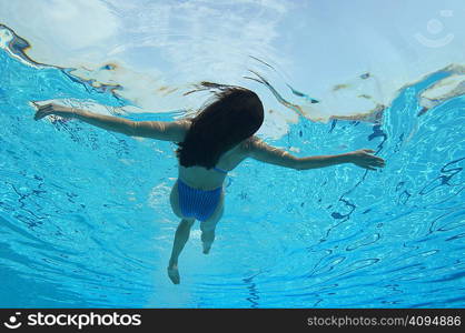 Woman floating in swimming pool