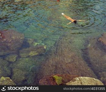 Woman floating on her back in the water