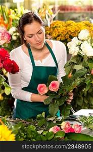 Woman florist preparing bouquet flowers shop retail arranging