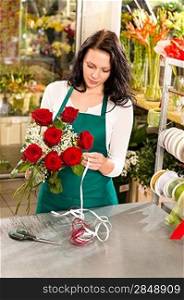 Woman florist working flowers roses market making bouquet store