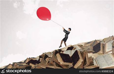 Woman fly on balloon. Businesswoman in suit and bowler hat flying on balloon