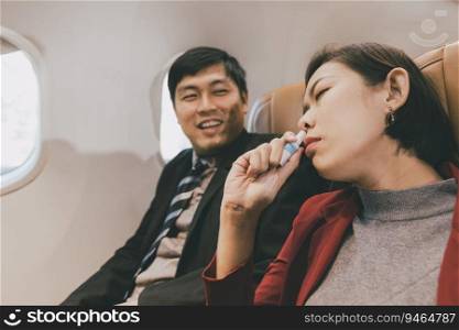 Woman fly sick dizzy or motion sickness and Inhaling herb during flight on board