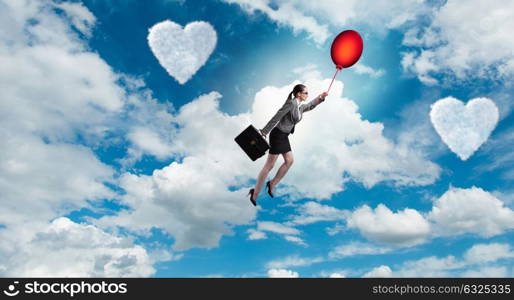 Woman flying balloons in romantic concept