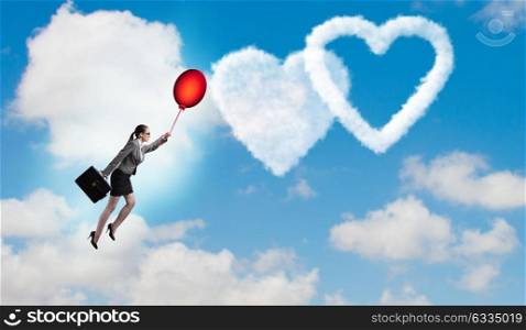 Woman flying balloons in romantic concept