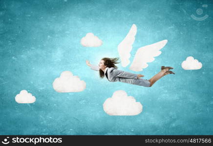 Woman flying high. Young businesswoman with drawn wings flying high in sky