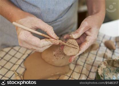 woman forming clay pot shape by hands, closeup in artistic studio.. woman forming clay pot shape by hands, closeup in artistic studio