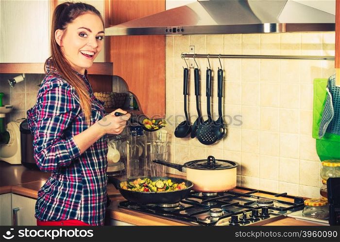 Woman frying frozen vegetables. Stir fry.. Woman in kitchen cooking stir fry frozen vegetables. Girl frying making delicious risotto. Dinner food meal. Instagram filtered.