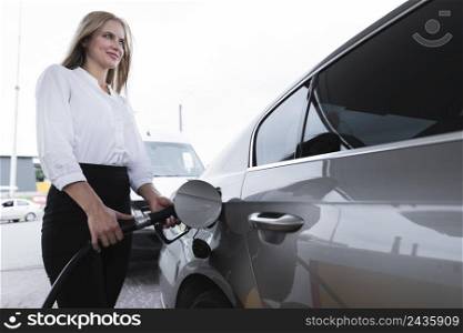 woman fueling gas station