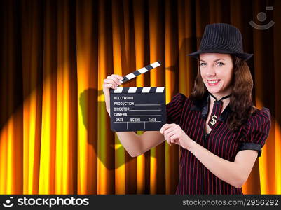 Woman gangster with movie clapper