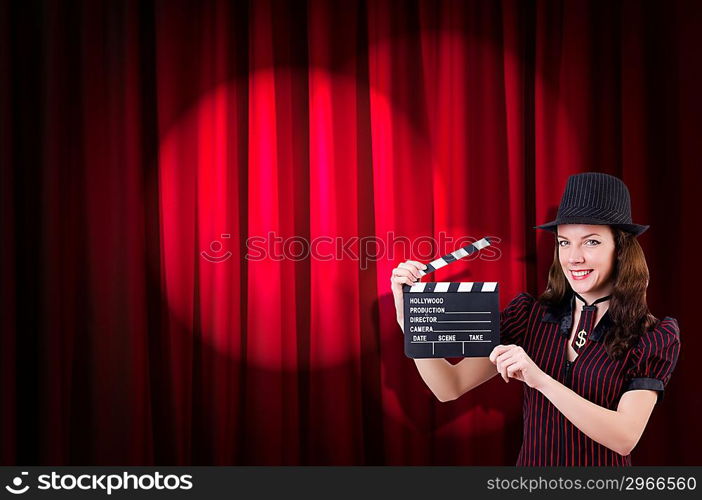 Woman gangster with movie clapper