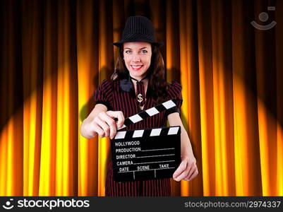 Woman gangster with movie clapper