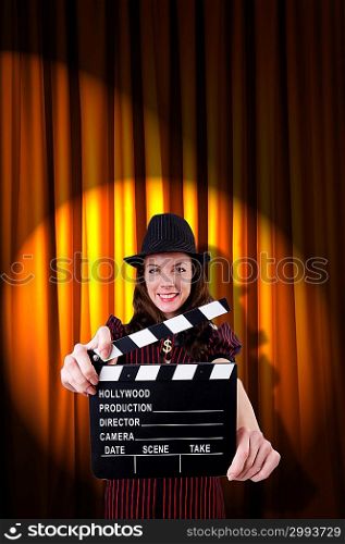 Woman gangster with movie clapper
