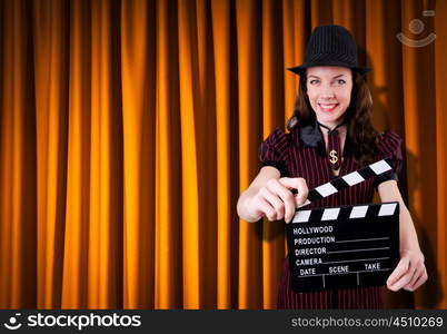 Woman gangster with movie clapper