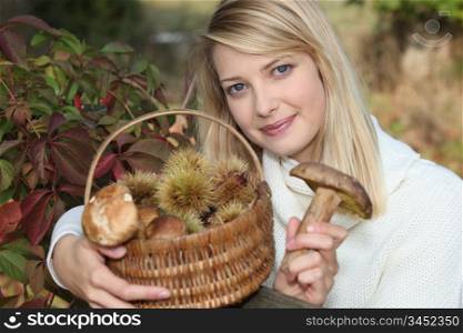 Woman gathering mushrooms and chestnuts