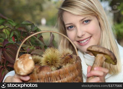Woman gathering mushrooms in basket