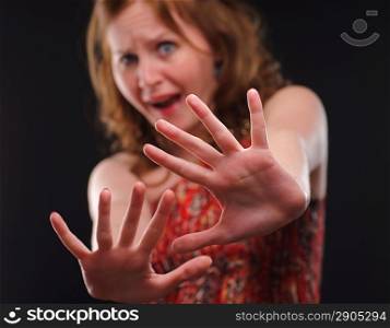 Woman gesturing stop sign.Defocused .