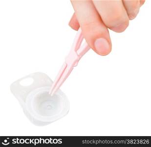 woman gets contact lens by tweezers from the container isolated on white background