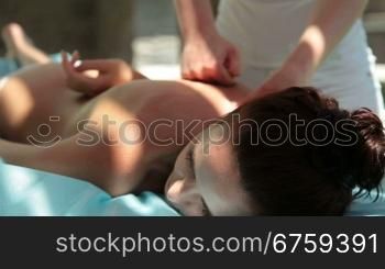 Woman getting an outdoor massage at a spa
