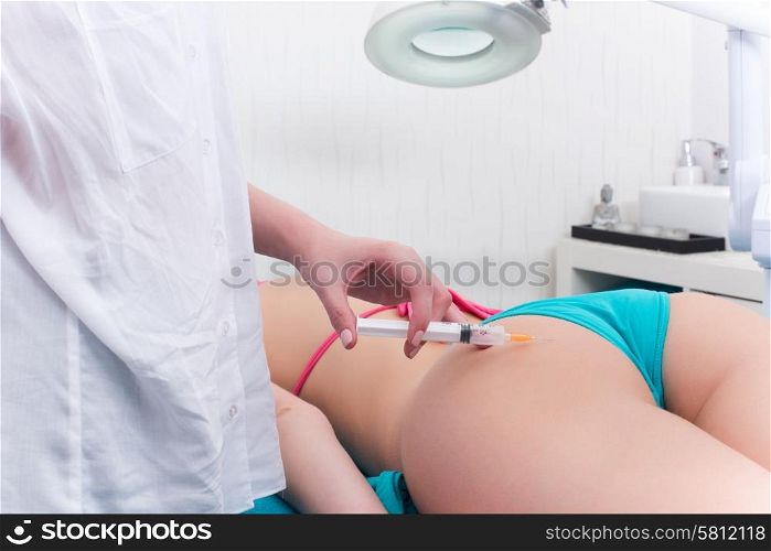 Woman getting anticellulite and anti fat therapy in beauty salon