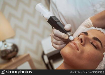 Woman getting cosmetic procedures at beauty center