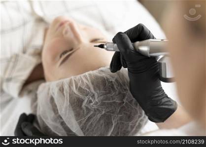 woman getting eyebrow treatment beauty salon