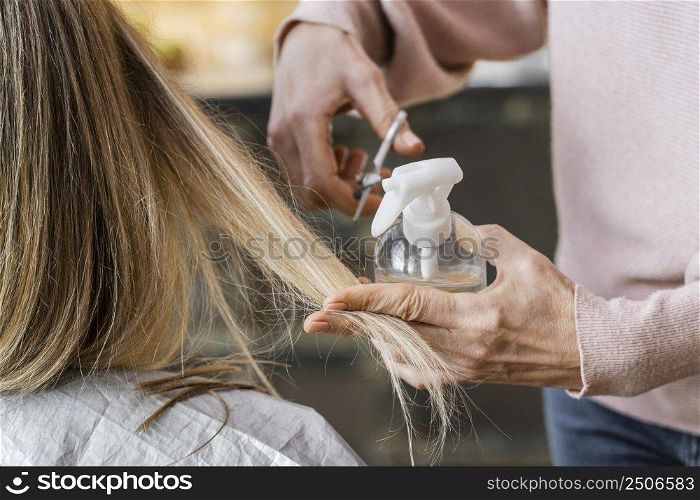 woman getting haircut home by hairdresser