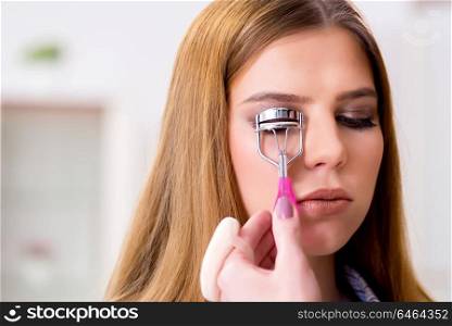 Woman getting her eyelashes done in the beauty salon