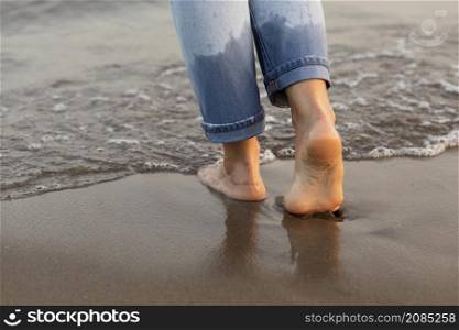woman getting her feet water beach