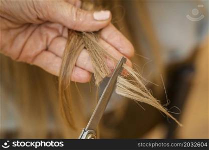 woman getting her hair cut home by hairstylist