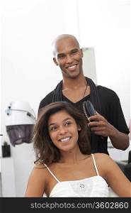 Woman getting her hair styled at beauty salon