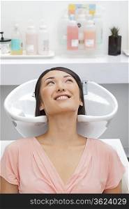 Woman getting her hair washed at beauty salon