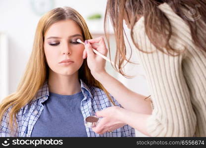 Woman getting her make-up done in beauty salon