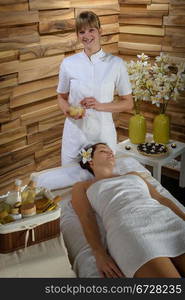 Woman getting massage treatment in luxury health spa centre