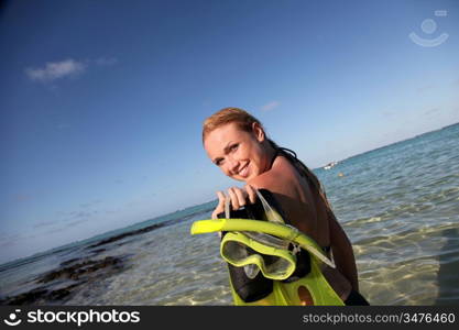 Woman getting out of water after snorkeling journey