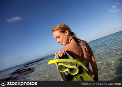 Woman getting out of water after snorkeling journey