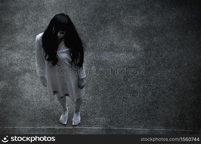 Woman ghost horror standing under building house her looking up, halloween concept
