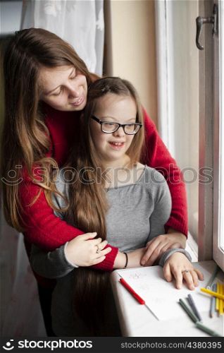 woman girl with down syndrome posing by window
