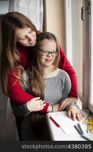 woman girl with down syndrome posing by window