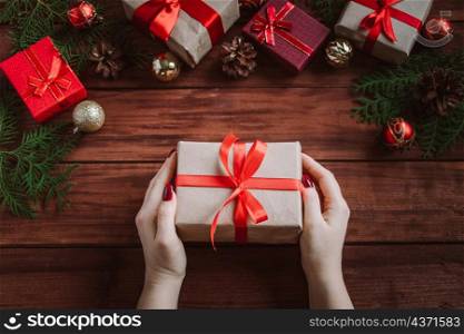Woman gives beautiful gift box with red bow. Christmas concept.. Woman gives beautiful gift box with red bow.