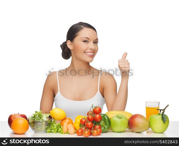 woman gives thumbs up with lot of fruits and vegetables